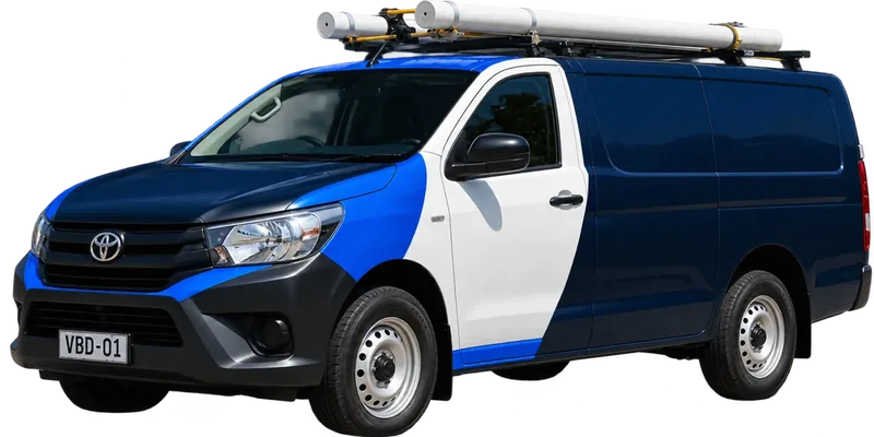 A licensed Croydon plumbing van loaded with pipe on the roof rack